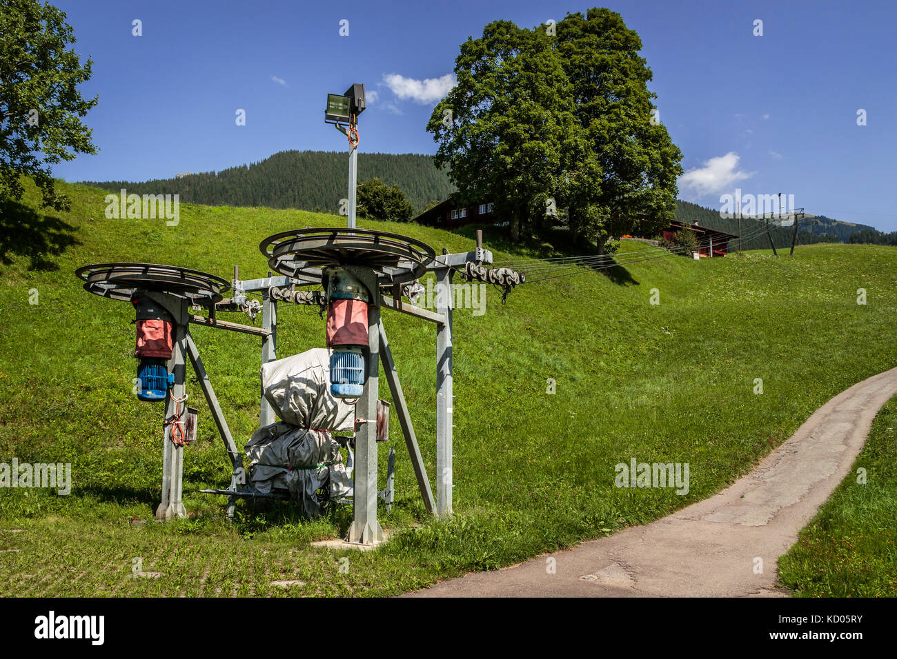 Uno ski lift di installazione in estate. in estate con erba verde, nessuna neve. Grindelwald, Oberland bernese, Svizzera Foto Stock