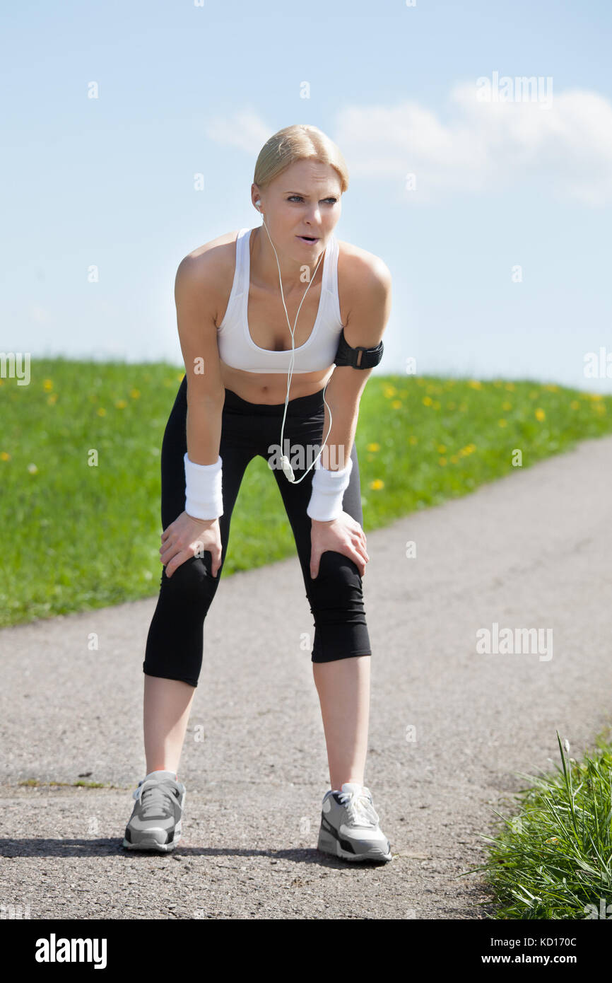 Foto esausta giovane donna rilassarsi dopo jogging Foto Stock