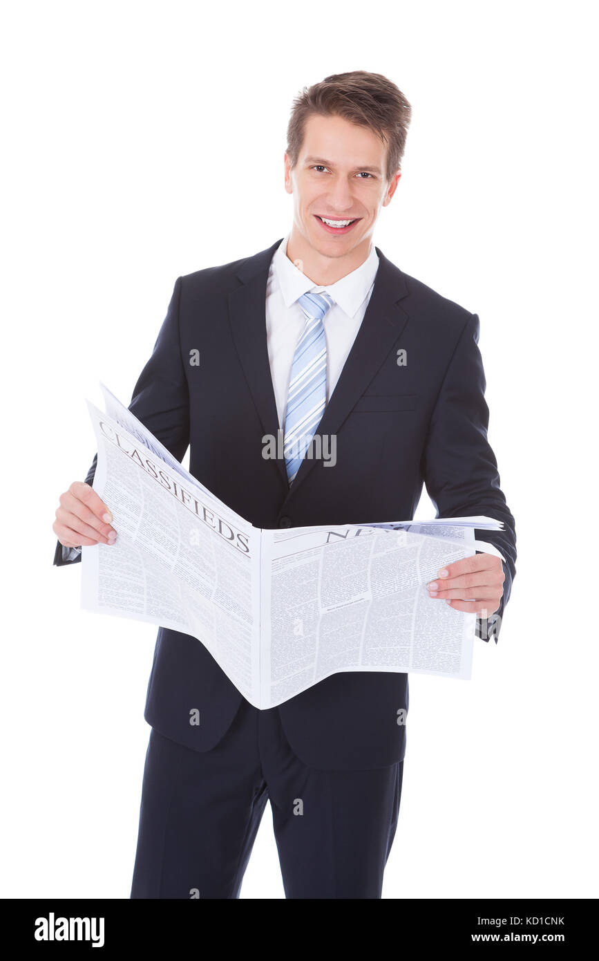 Felice giovane impreditore azienda giornale su sfondo bianco Foto Stock