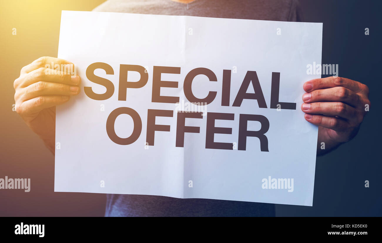 Uomo con banner con offerte speciali testo stampato Foto Stock