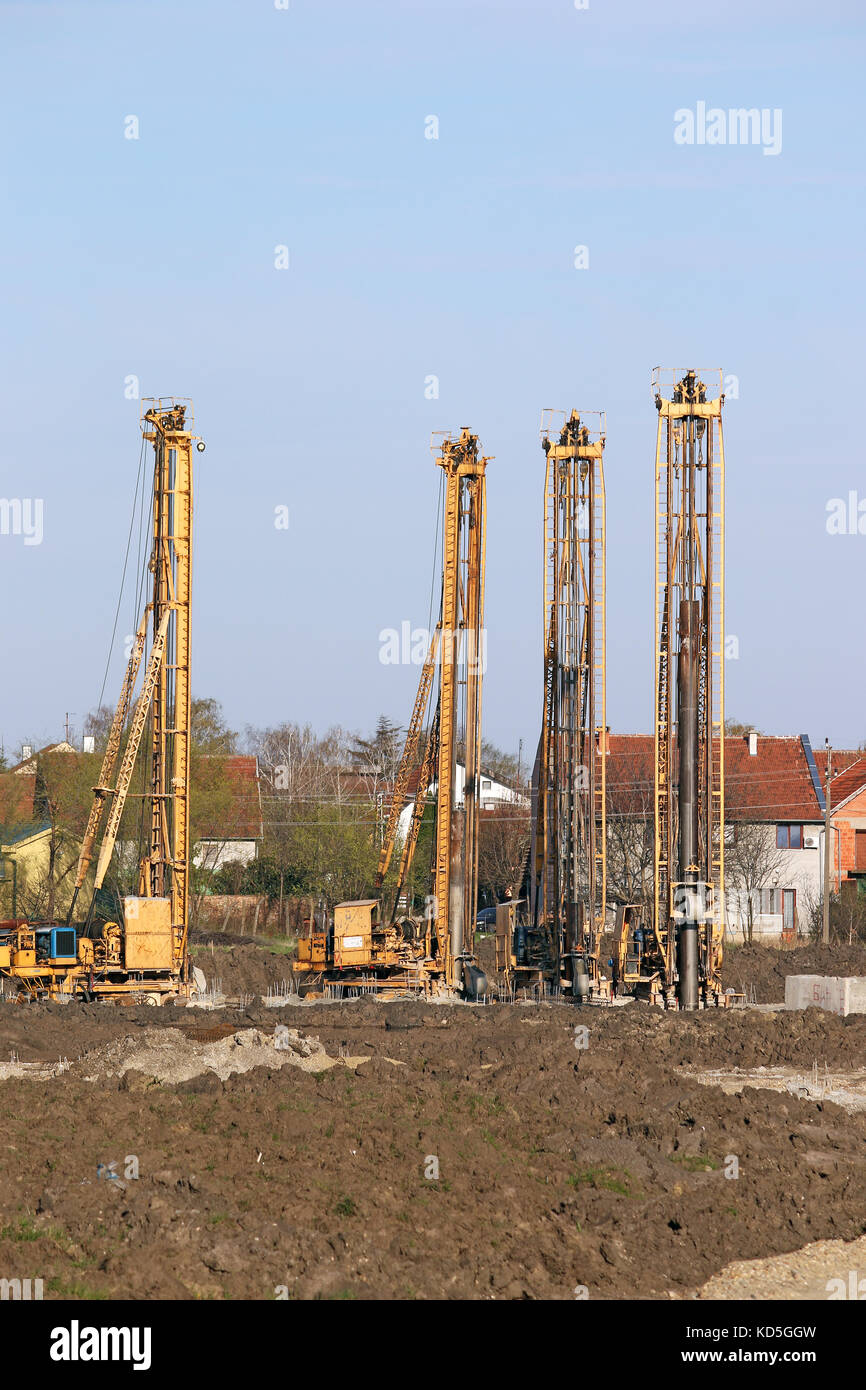 Idraulico macchine di foratura sul sito in costruzione Foto Stock