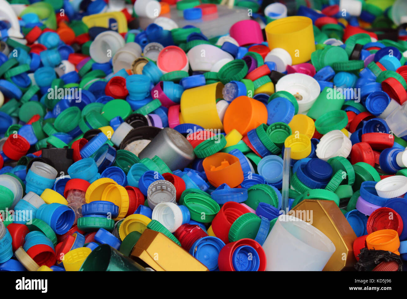 Numero enorme di colorati di bottiglie in plastica tops dettaglio. Sostenibilità, riciclare e risparmiare i temi dell'ambiente Foto Stock