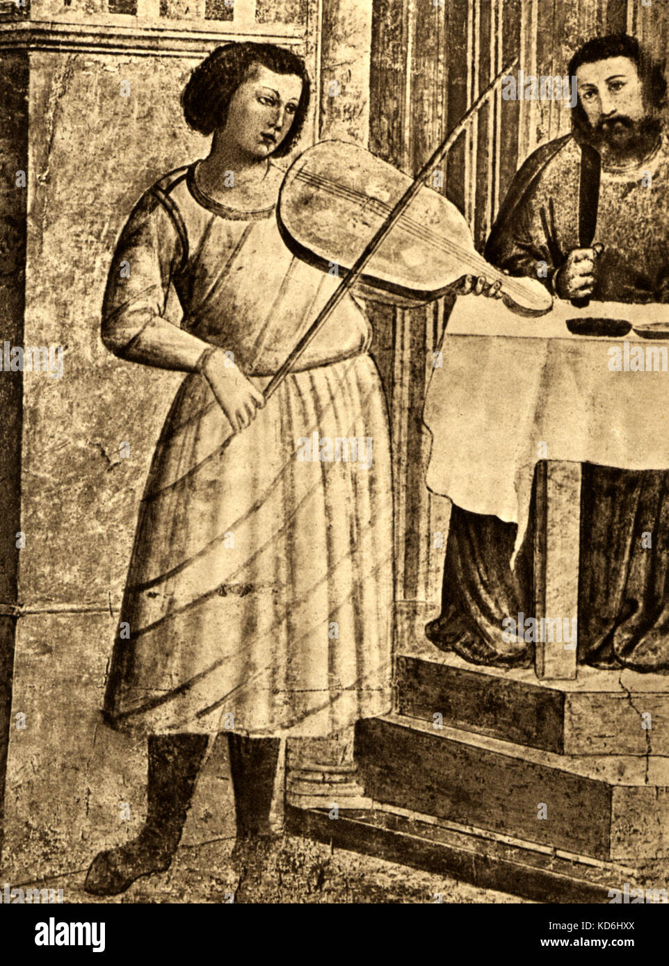 L'uomo gioca la vielle. Dipinto da Giotto, 'Il convito in casa di erodere', (il banchetto presso la Casa di Erode). Storia della Musica, Volume One, A. della Corte, G. Pannain. Foto Stock