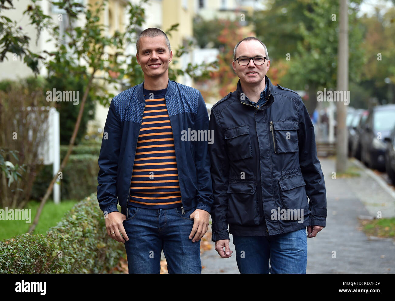 Berlino, Germania. 10 ottobre 2017. Michael e Kai Korok camminano lungo una strada a Berlino, Germania, 10 ottobre 2017. La coppia gay ha vinto il diritto di adottare un bambino dopo decenni di attesa. Sono la prima coppia a Berlino ad adottare un bambino. La decisione è stata presa solo dieci giorni dopo che il diritto al matrimonio gay è stato approvato dal parlamento tedesco. Crediti: Britta Pedersen/dpa-Zentralbild/dpa/Alamy Live News Foto Stock