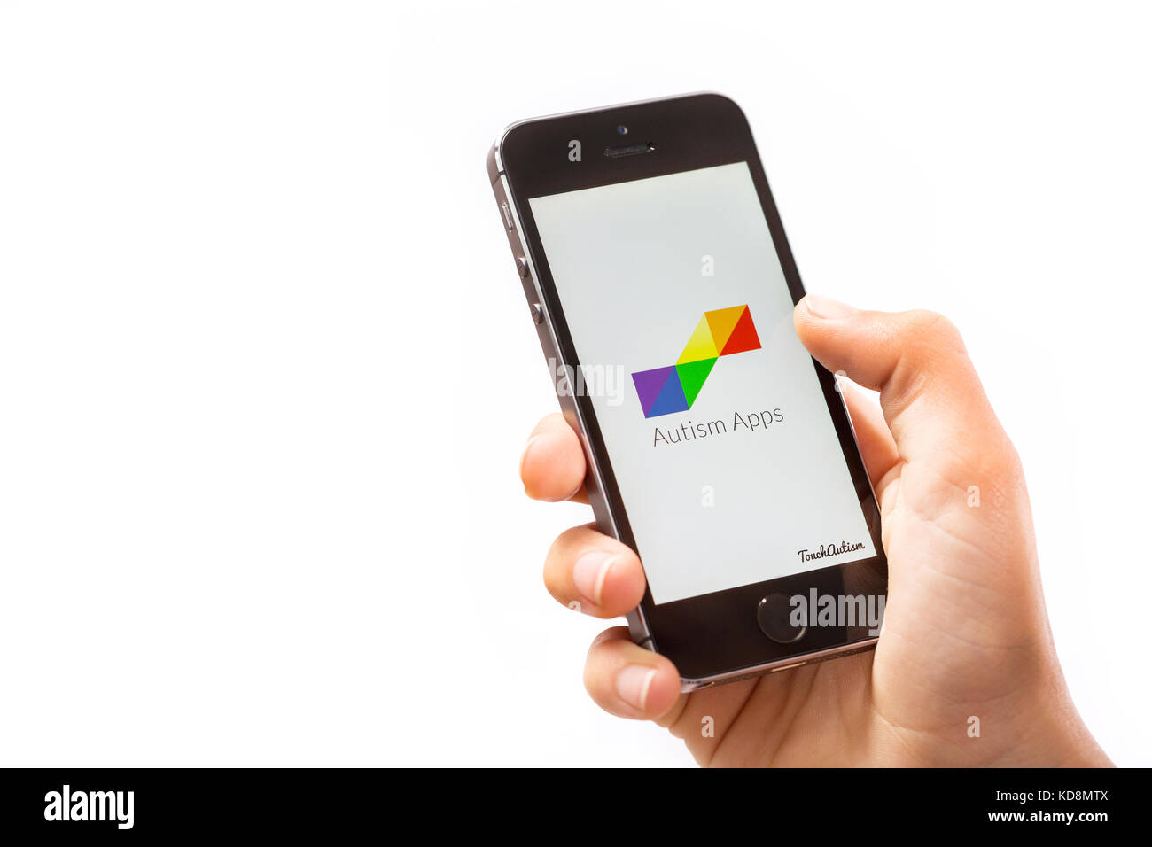 Un ragazzo utilizzando l'Autismo App su un telefono cellulare Foto Stock