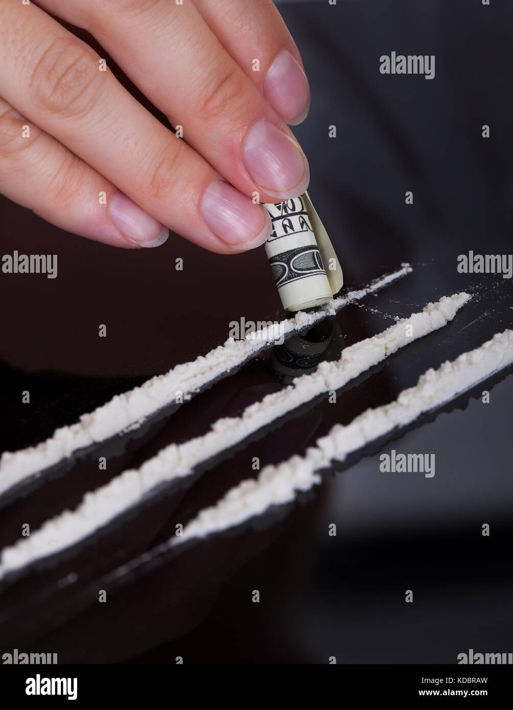 Close-up di persona lo sniffing cocaina farmaci con laminati nota banca Foto Stock