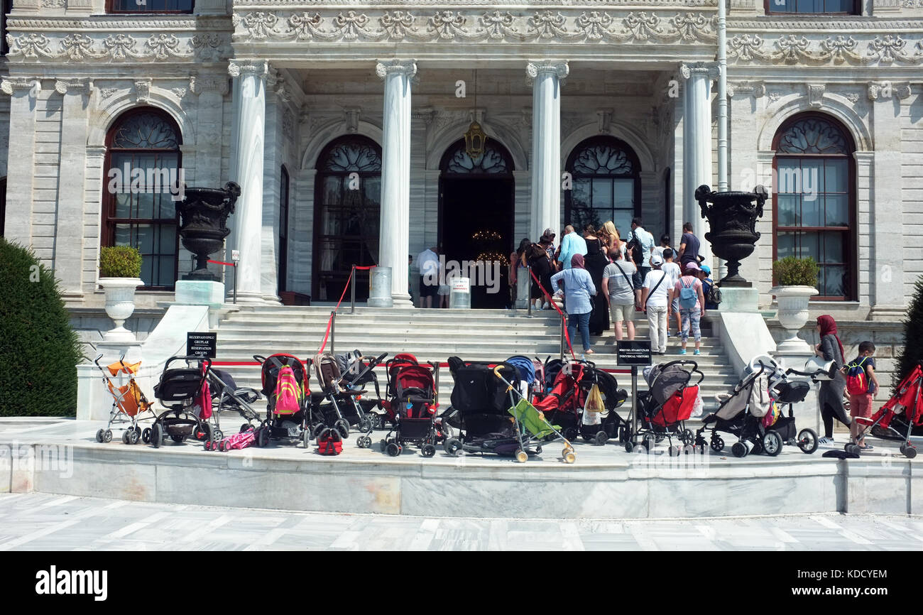 Istanbul, Turchia - 29 agosto 2017: turisti lascia buggy nella parte anteriore dell'edificio mentre sono in coda per i biglietti per visitare Palazzo Dolmabahce in Ist Foto Stock