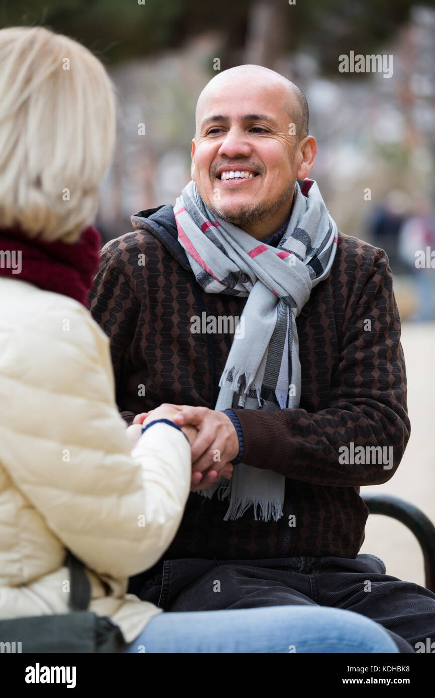 Ritratto di Allegro sorridente coppia matura avente una interessante conversazione all'aperto Foto Stock