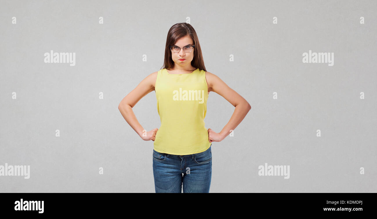 Insoddisfatto wicked girl su sfondo grigio. Foto Stock