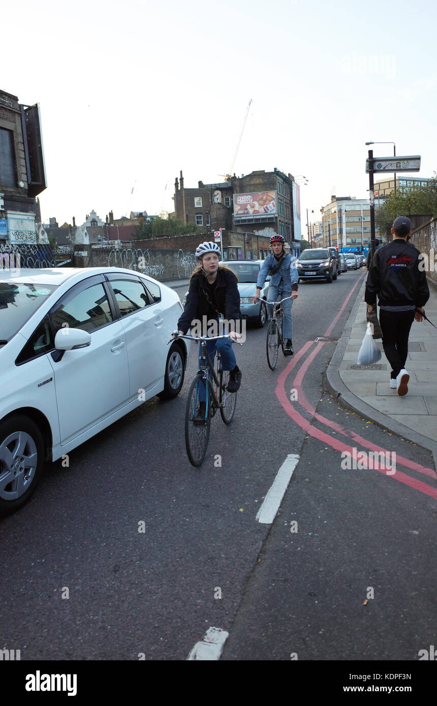 Escursioni in bicicletta lungo il lato del traffico di veicoli a Londra in Inghilterra Foto Stock
