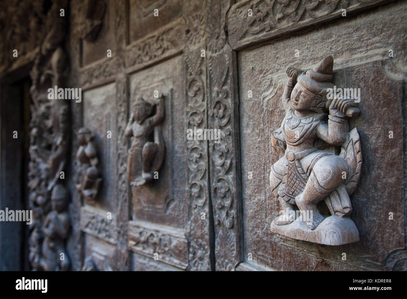 Un dettaglio del monastero Shwenandaw del XIX secolo che mostra un intaglio in legno di un mito buddista nella città di Mandalay in Myanmar Foto Stock