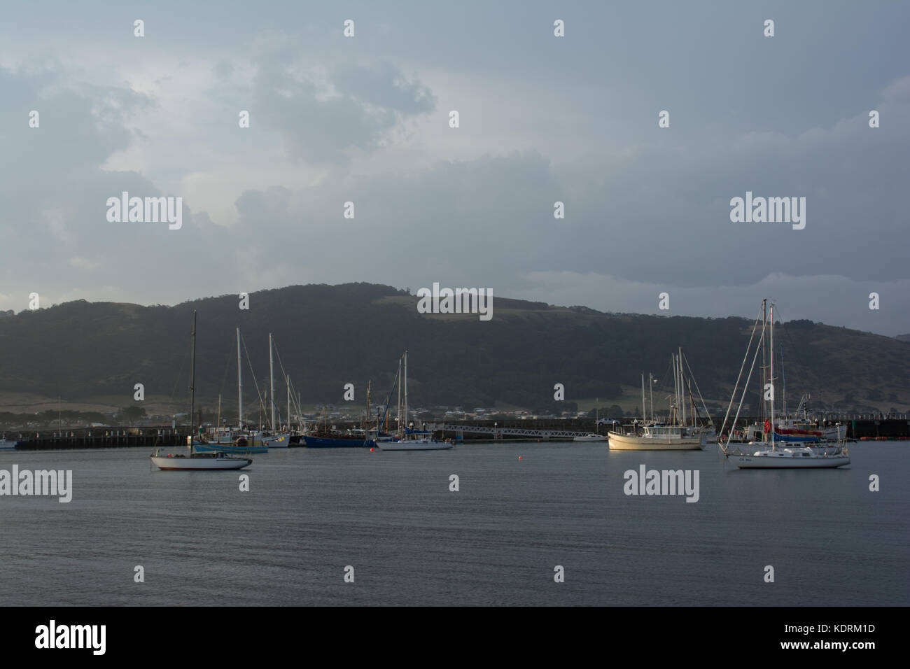 Barche di seduta tranquillamente in acqua di una marina al tramonto. Foto Stock