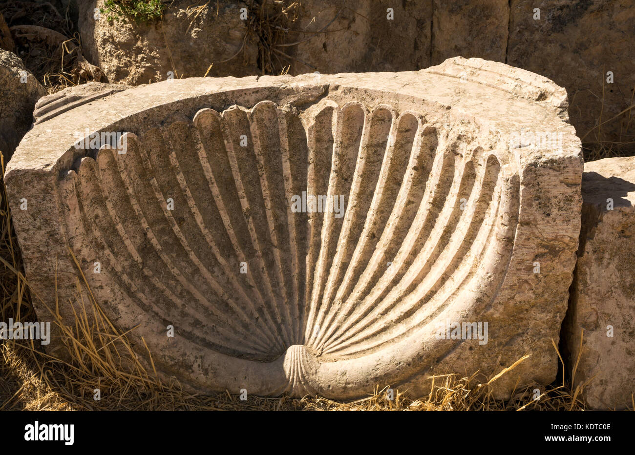 Close up rovinato decorativi in pietra scolpita smerlo shell carving, città romana di Jerash, antica Gerasa, sito archeologico, nel nord della Giordania, Medio Oriente Foto Stock