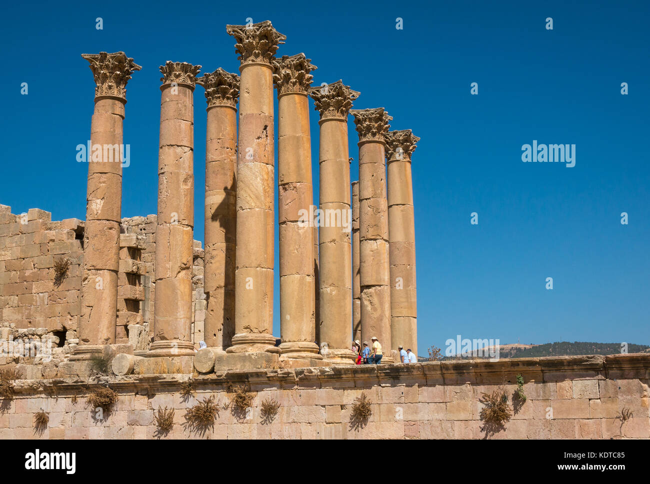 Gruppo turistico entrando in Tempio di Artemide nella città romana di Jerash, antica Gerasa, sito archeologico in Giordania, Medio Oriente Foto Stock