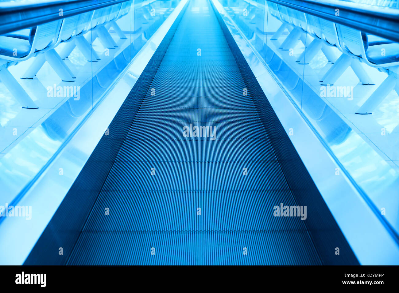 Concetto di viaggio. escalator cammino interno moderno aeroporto terminale. immagine in colori blu Foto Stock
