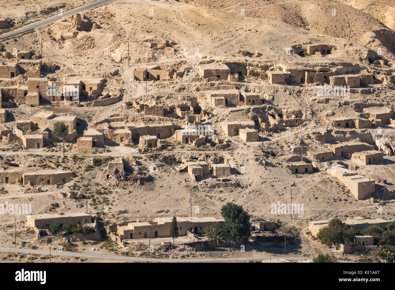 Vista sulla Kings Highway della valle del deserto con case di mattoni di fango in un villaggio, Giordania, Medio Oriente Foto Stock