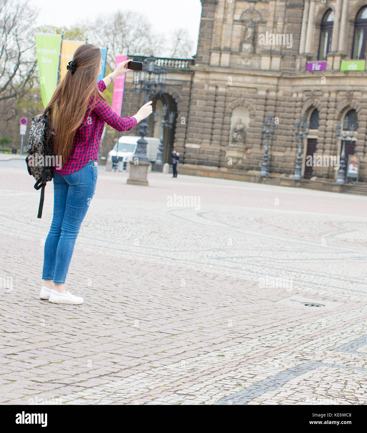 Giovane donna con capelli lunghi utilizza lo smartphone in unione città vecchia Foto Stock