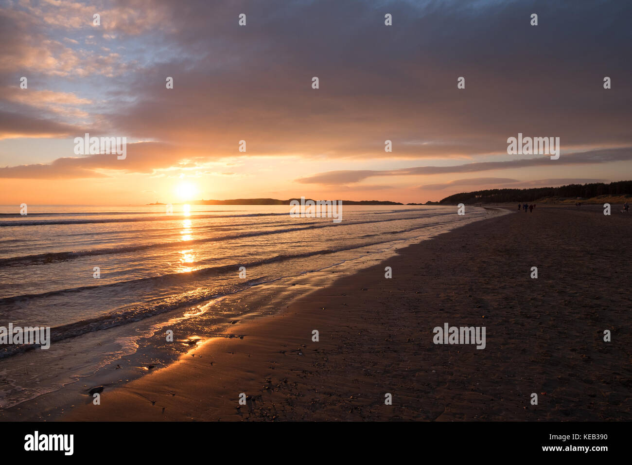 Tramonto perfetto a spiaggia deserta, Gentle Waves e golden sun riflettendo in acqua calma Foto Stock