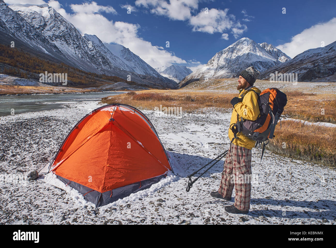 Escursionista con zaino in campeggio in montagna durante la primavera. backpacker con bierd guardando in alto. Foto Stock