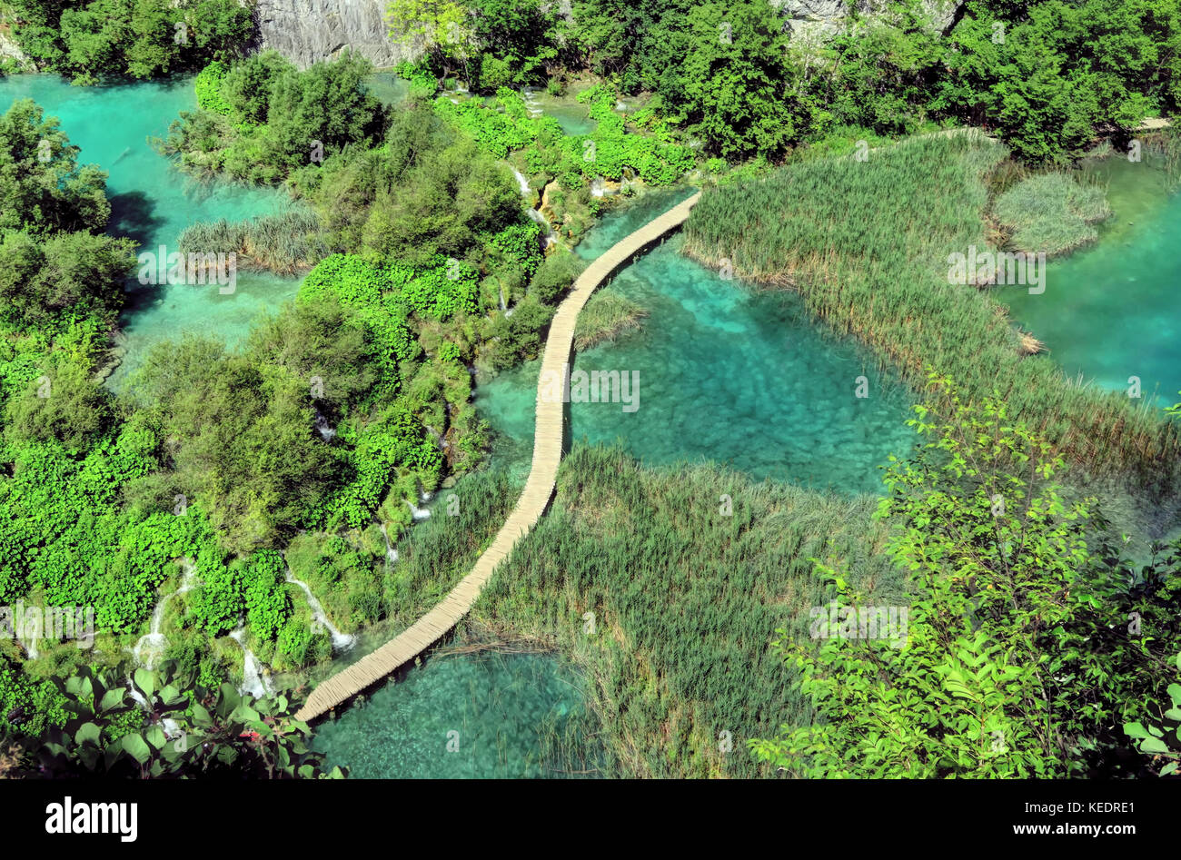 Vista aerea laghi Plitvice famosa acqua di zaffiro, cascate e passerella a serpentina. Foto Stock