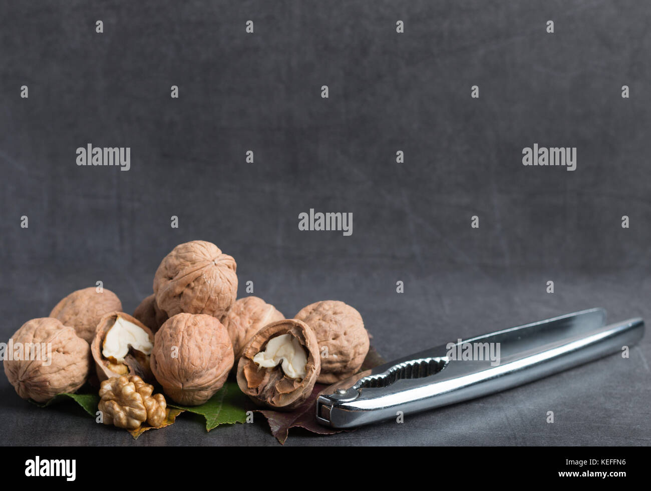 Bio le noci su un tavolo in pietra con uno schiaccianoci Foto Stock
