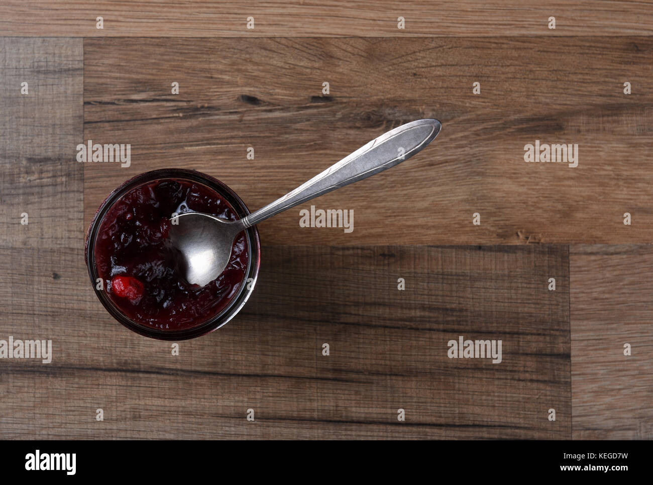 Freschi Fatti in casa salsa di mirtilli e cucchiaio in legno di un tavolo da cucina. Foto Stock