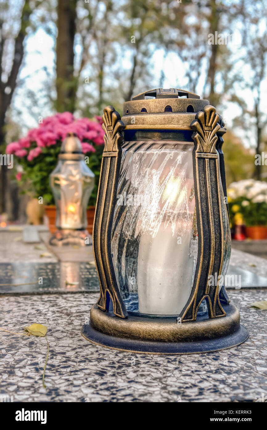 Vetro candela votiva accesa sulla lapide di marmo Foto Stock
