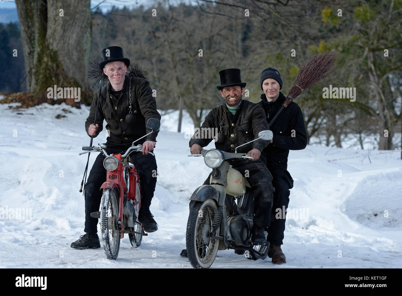 Spazzatrici camino in inverno sul vecchio ciclomotori, Alta Baviera, Baviera, Germania Foto Stock