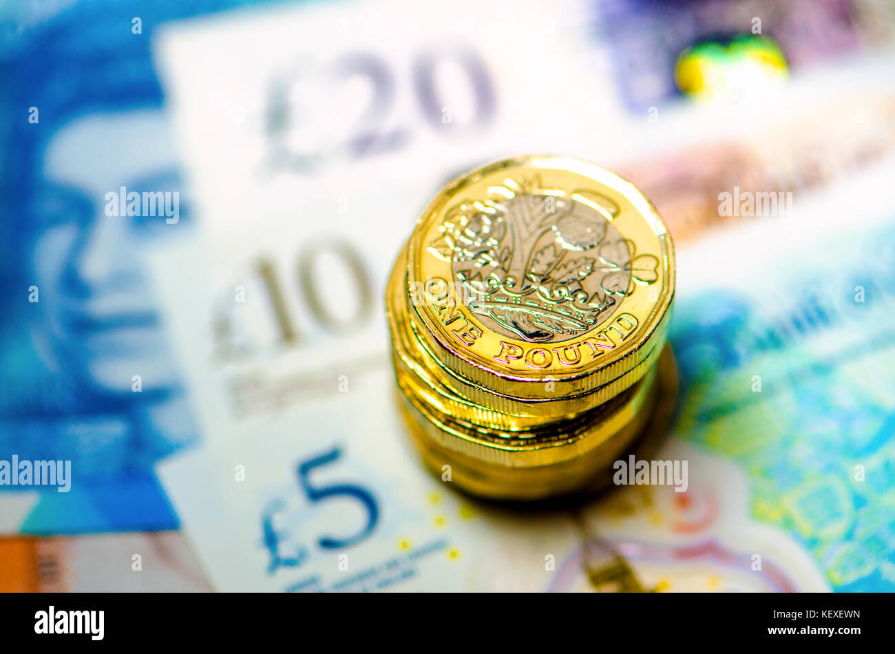 Valuta britannica - pila di nuovo (2016) pound monete su £5 £10, £20 note Foto Stock