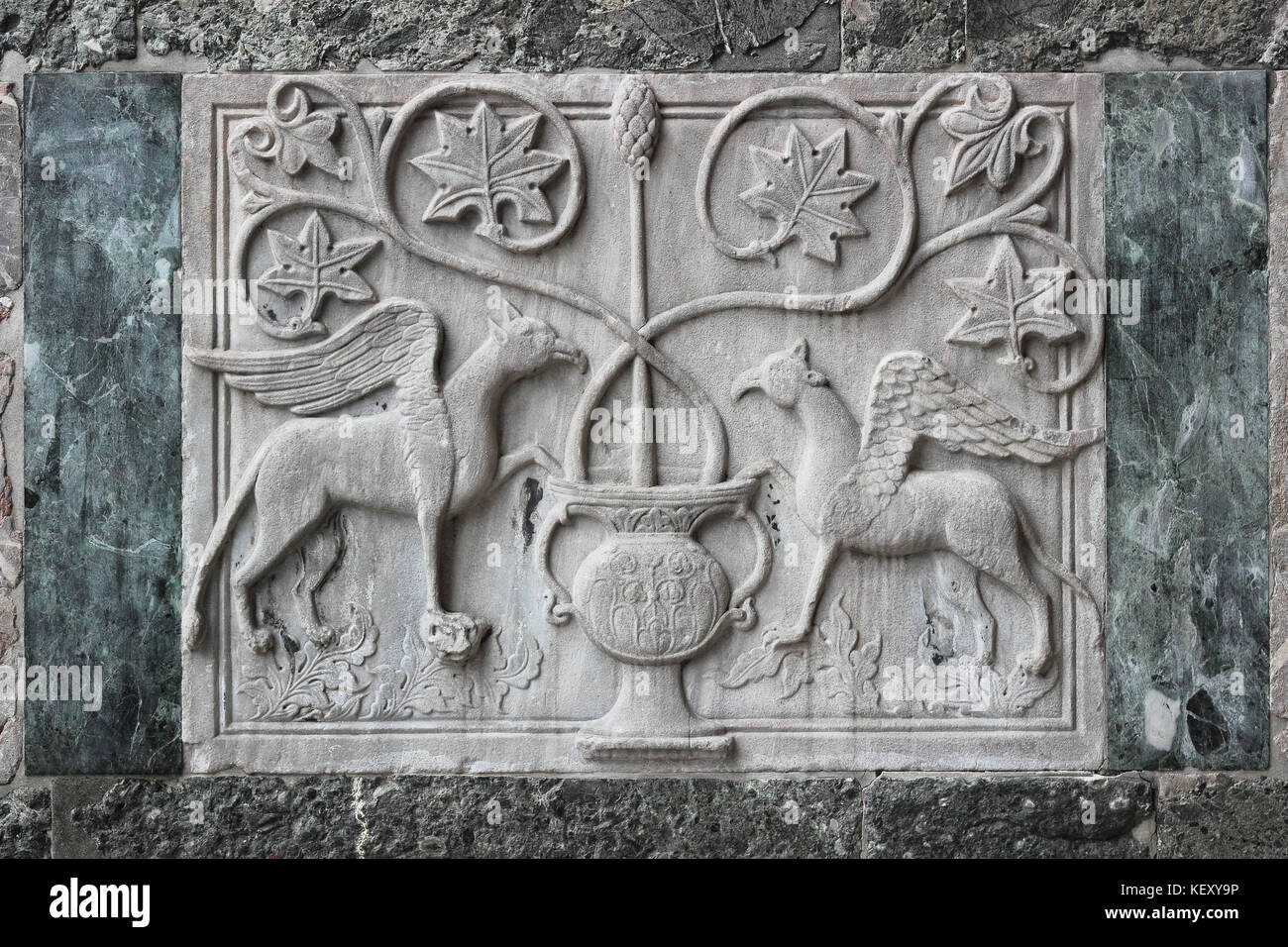 Dettaglio di un antico rilievo in marmo bizantino che raffigura grifi alati sulla facciata esterna della Basilica di San Marco a Venezia, Italia Foto Stock