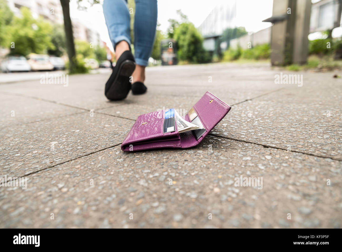 La donna a piedi dopo aver perso il suo portafoglio su strada Foto Stock