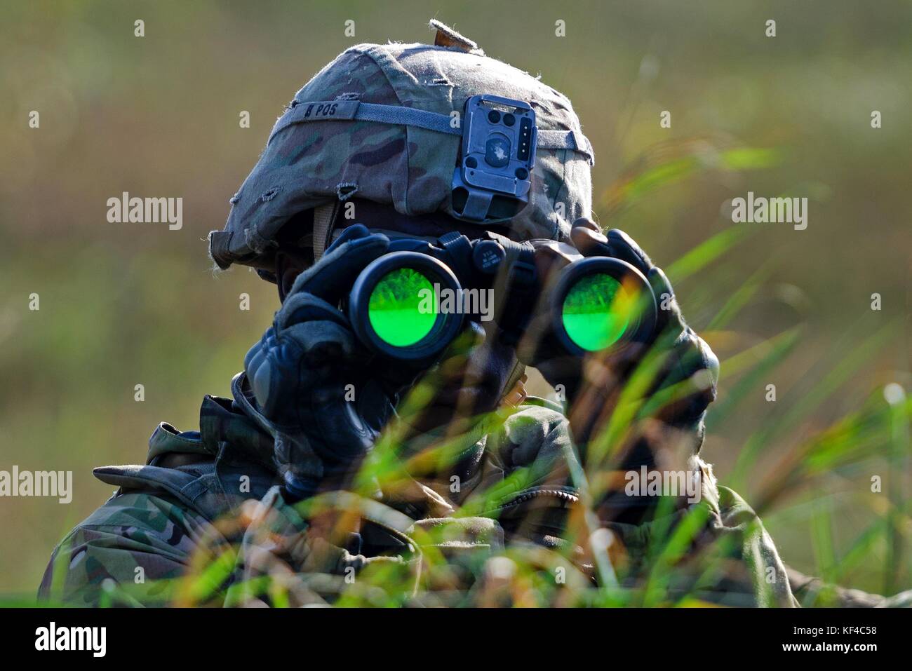 Un soldato dell'esercito americano scansiona l'orizzonte con un binocolo durante l'esercitazione Dragon presso l'area di addestramento Bemowo Piskie il 26 settembre 2017 vicino a Orzysz, Polonia. Foto Stock