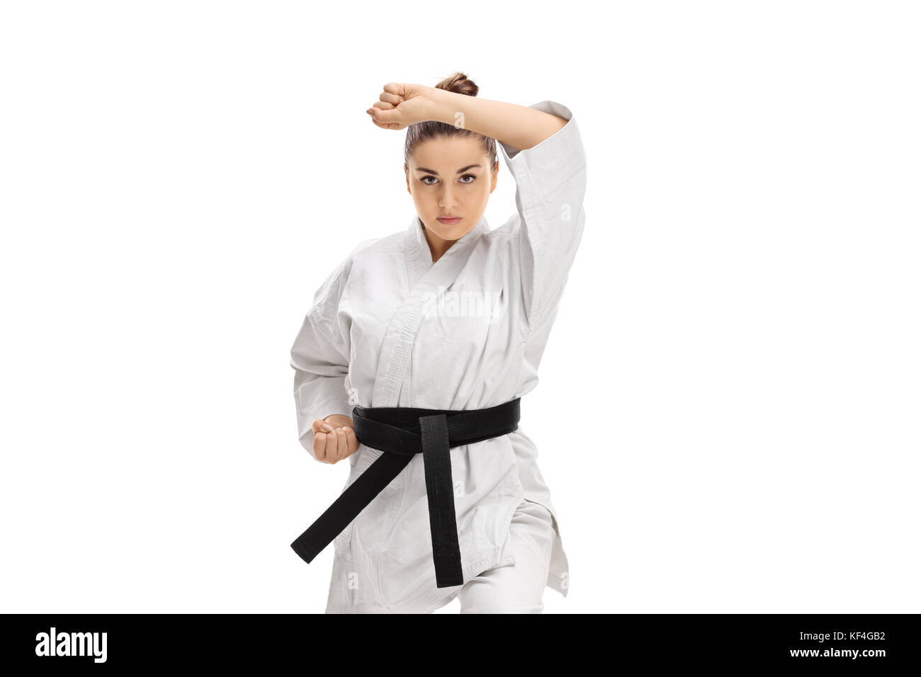 Ragazza in un kimono facendo un karate kata isolati su sfondo bianco Foto Stock