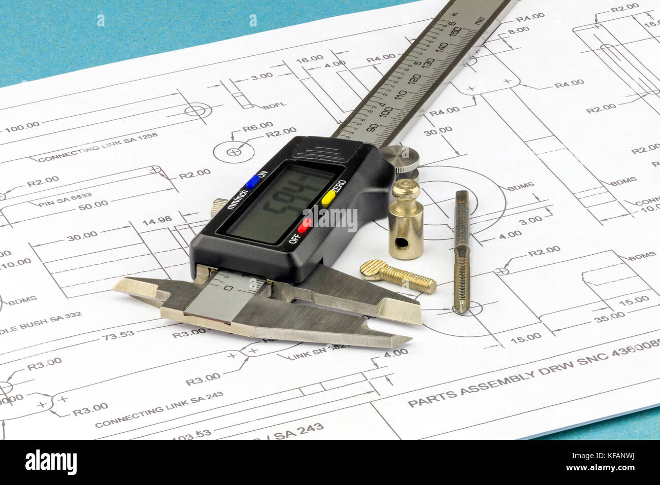Engineering un calibro a corsoio, rubinetto metallico e le parti metalliche poste su un disegno di ingegneria sfondo Foto Stock