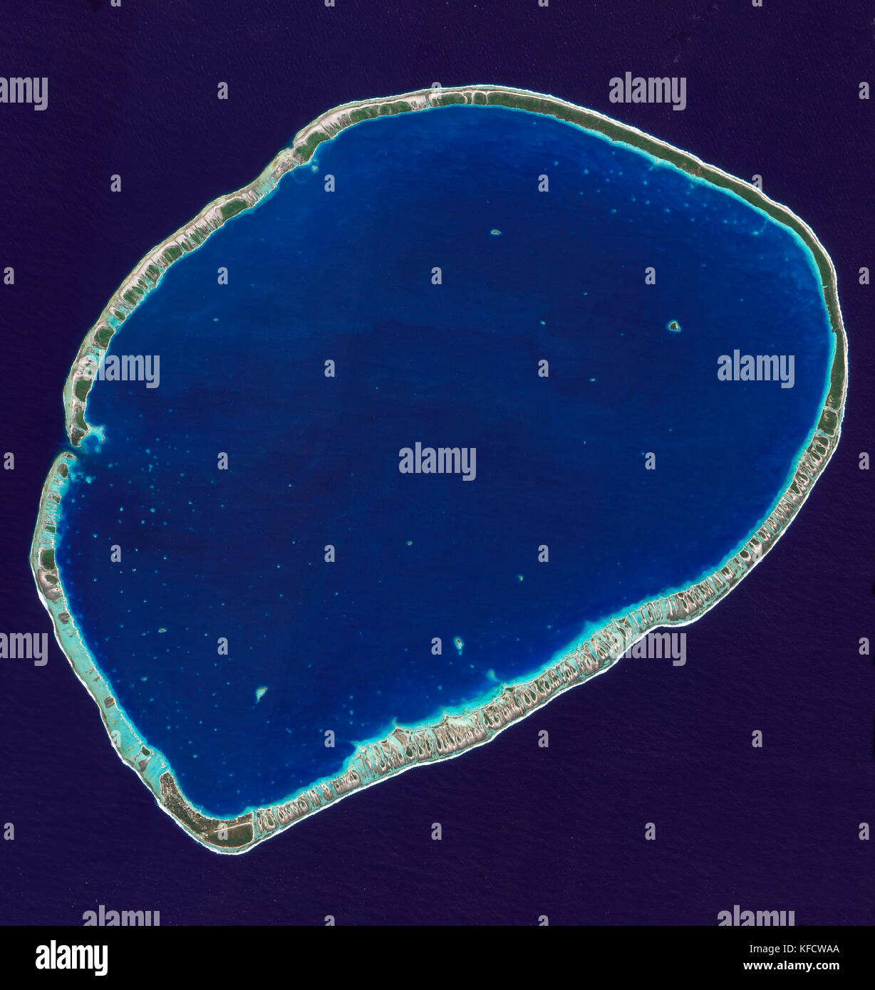 La parte meridionale di Tikehau Atoll, uno dei 78 atolli corallini che compongono l'arcipelago delle Tuamotu. Le patch di corallo rendono star-come macchie. Foto Stock