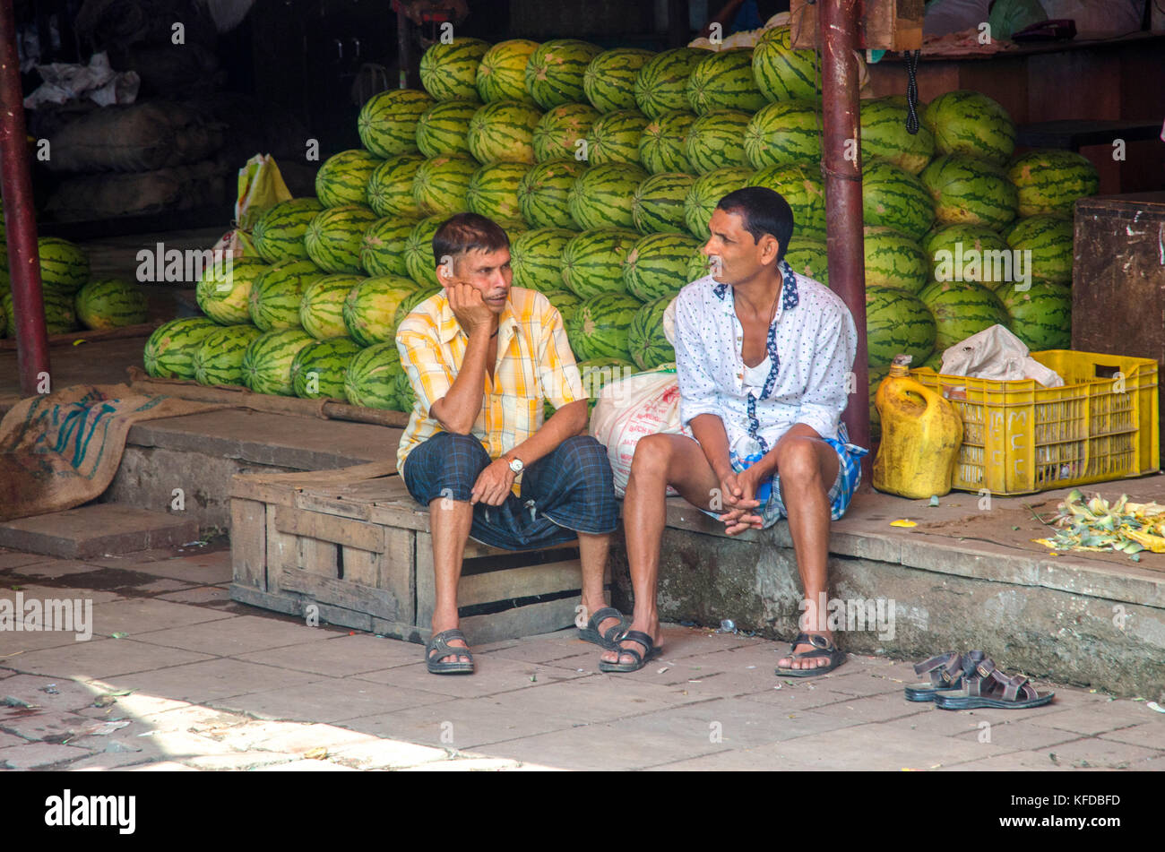 Gli uomini seduti al mercato Crawford in Mumbai, India Foto Stock
