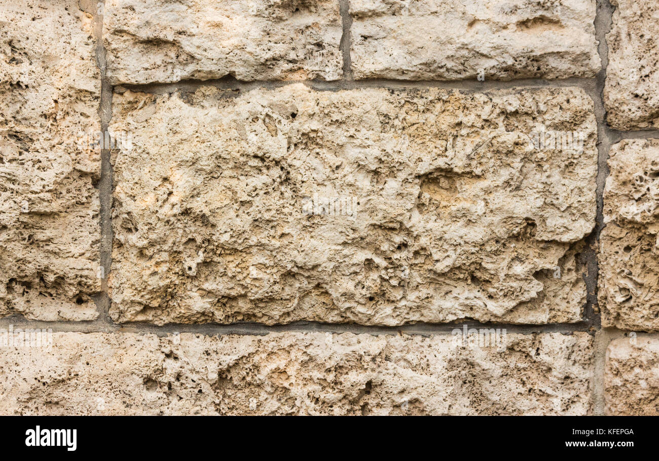 Clos fino di beige muro di pietra texture di superficie di sfondo Foto Stock