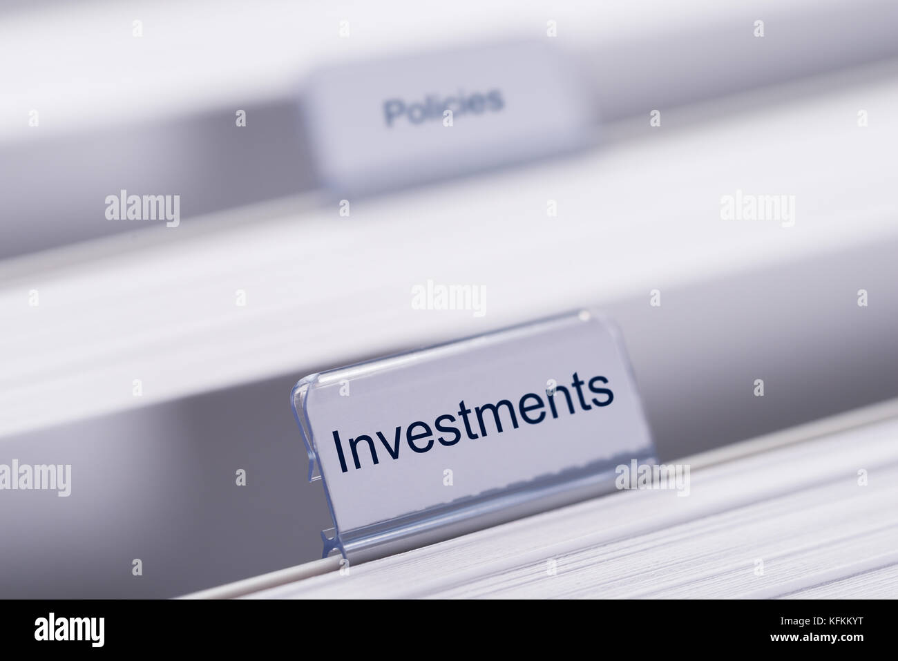 Primo piano di investimenti e di politiche linguette sulle cartelle Foto Stock