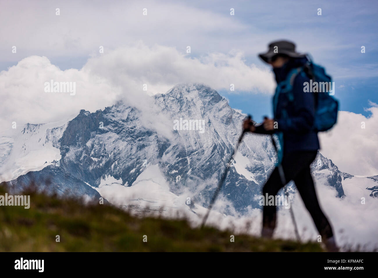 Zinal, Svizzera - woman hiking. Sul retro è il Weisshorn (4506m 14,783ft), una montagna nelle Alpi Pennine nel canton Vallese. Foto Stock