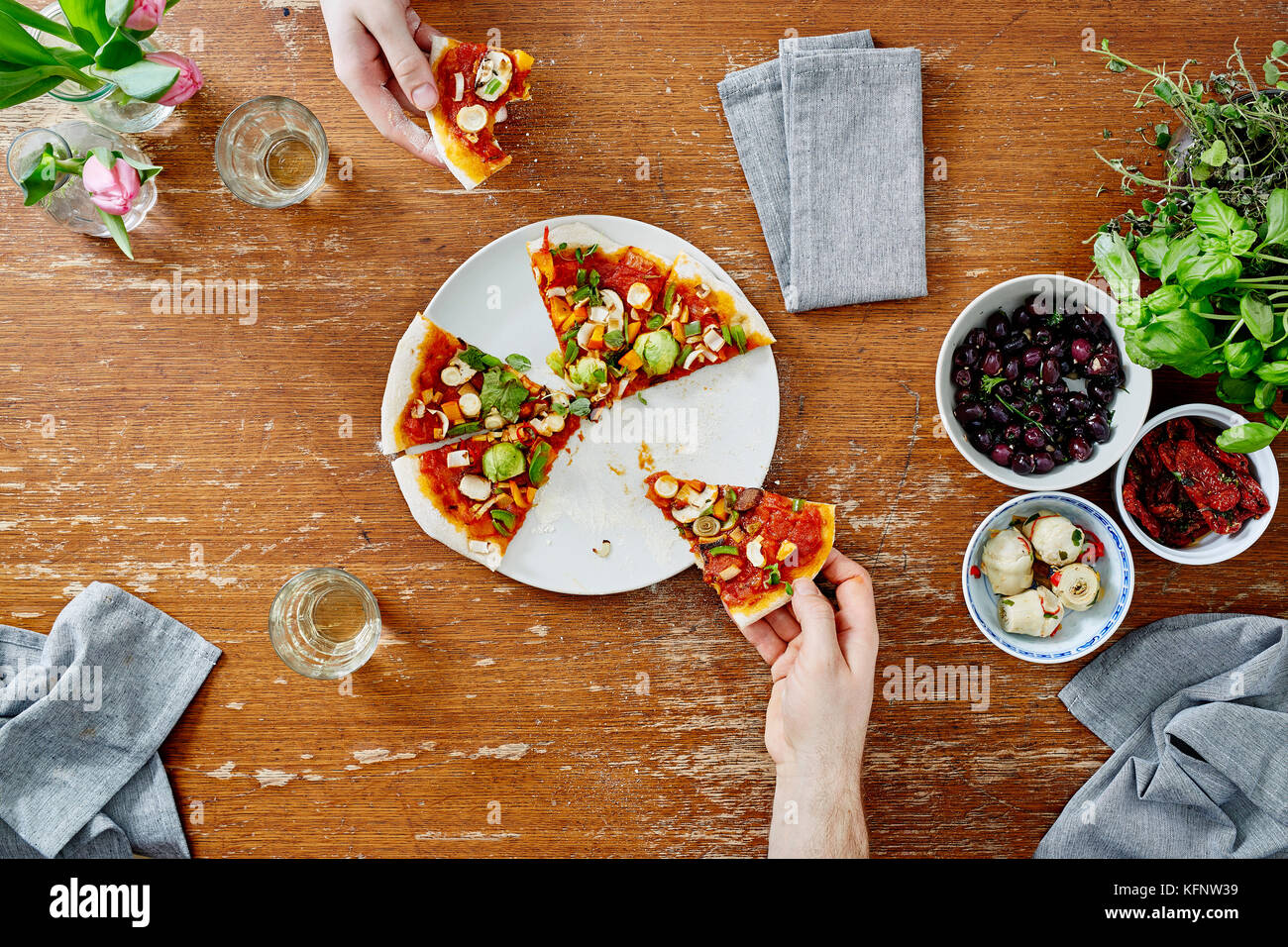 Riunione sociale mangiare e condividere pizza organico Foto Stock