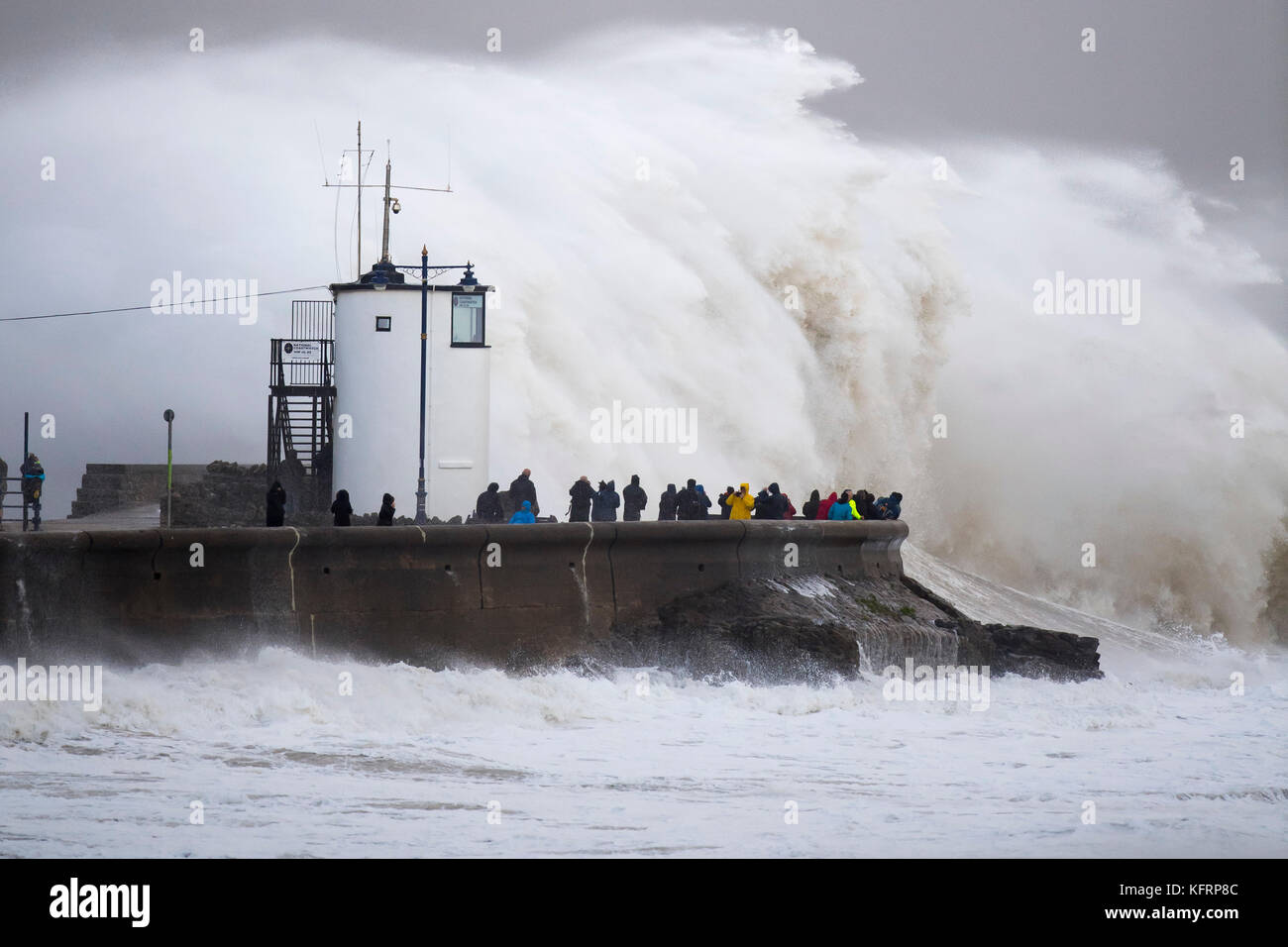 Onde infrangersi contro la parete del porto durante la tempesta Brian a Porthcawl, nel Galles del Sud. Il Met Office hanno rilasciato un giallo allarme meteo per vento e ha Foto Stock