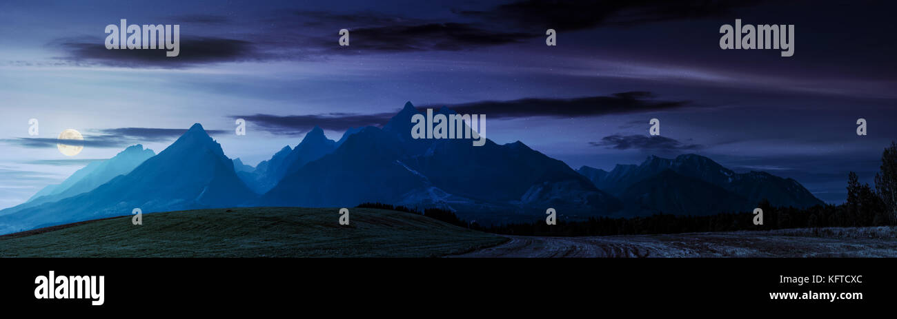Campi rurale vicino a monti Tatra in estate di notte. bellissimo panorama della zona agricola. splendida montagna cresta con alti picchi rocciosi Foto Stock
