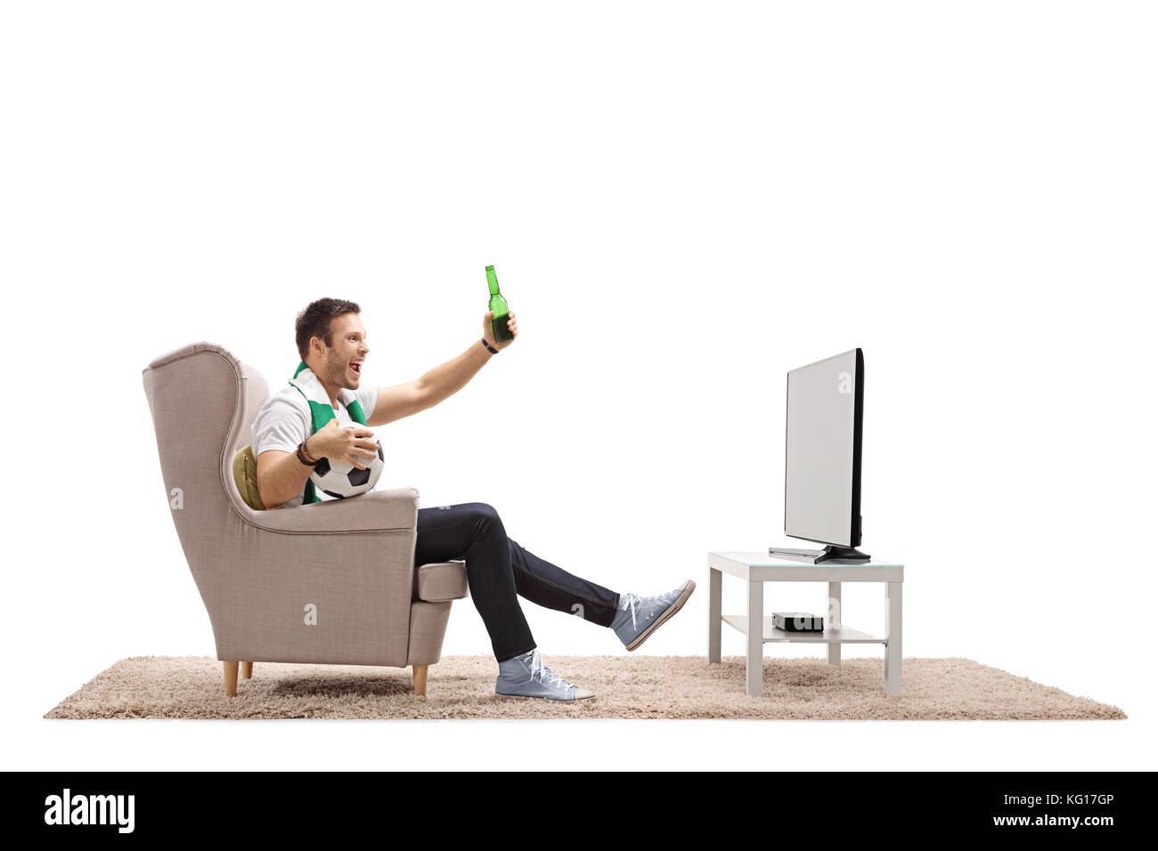 Emozionato tifoso di calcio guardando la partita di calcio in televisione e avente una birra isolato su sfondo bianco Foto Stock