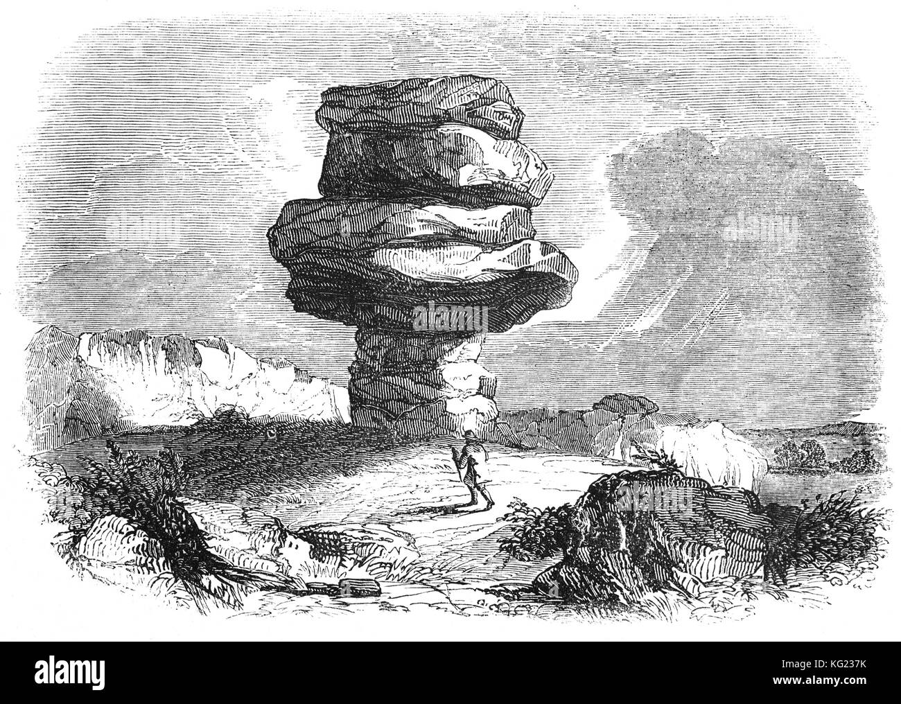 Il Cheesewring, un granito tor in Cornwall, Regno Unito, situato sul versante orientale di Bodmin Moor su Stowe collina a circa 1 miglio a nord-ovest del villaggio di tirapiedi e a quattro miglia a nord di Liskeard. Si tratta di un naturale formazione geologica, uno sperone di roccia di granito in lastre formate da agenti atmosferici. Foto Stock
