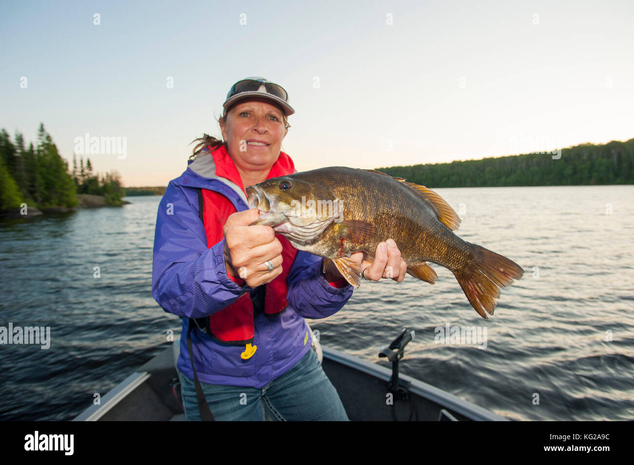 Donna pescatore con smallmouth bass Foto Stock