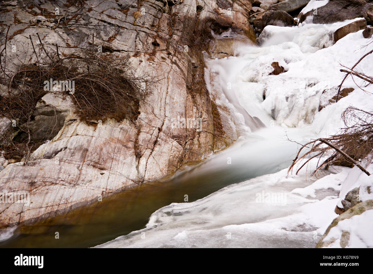 Un piccolo ruscello con ghiaccio nelle montagne austriache. Foto Stock