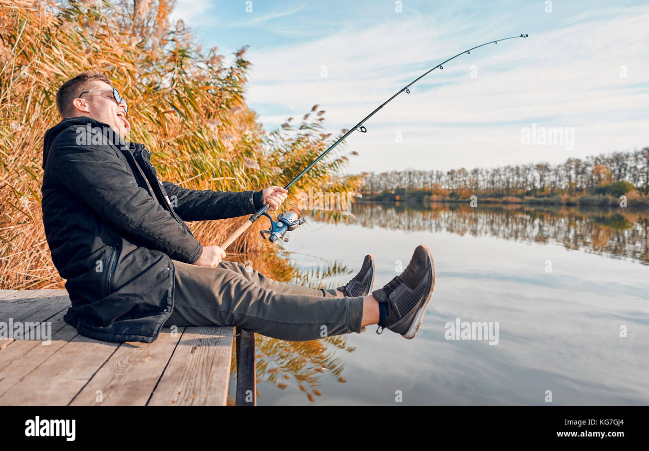 L uomo è la pesca sul ponte Foto Stock