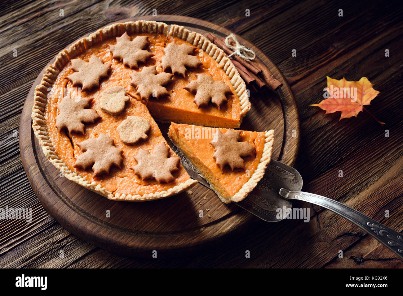 In casa torta di zucca decorata con pan di zenzero cannella cookie sul tavolo di legno. tutta la torta di zucca Foto Stock