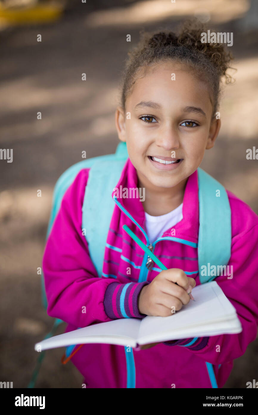 Ritratto di ragazza iscritto nel libro in posizione di parcheggio Foto Stock