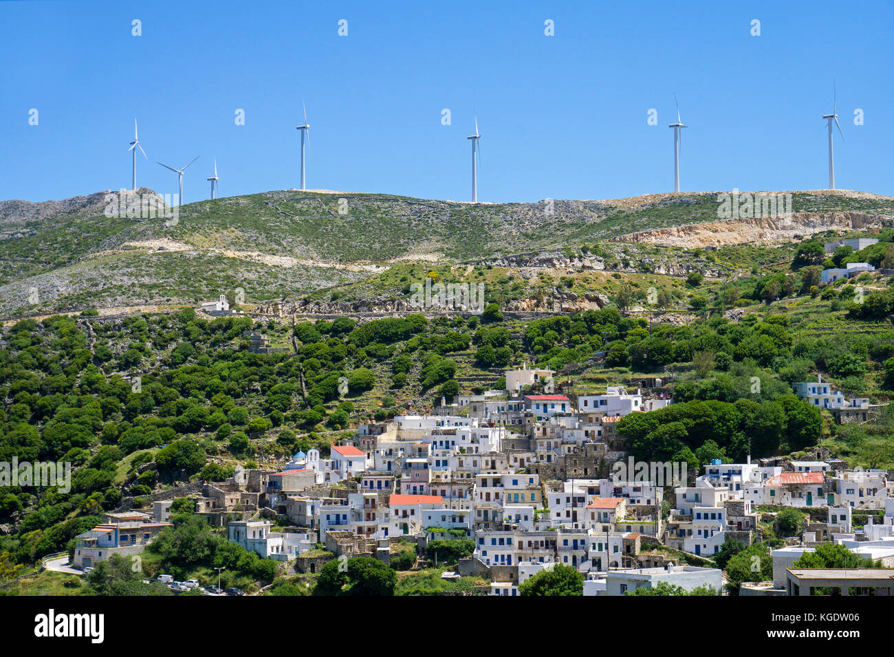 Le turbine eoliche al di sopra di un villaggio di montagna a nord di Naxos, Cicladi Grecia, Mare Mediterraneo, Europa Foto Stock